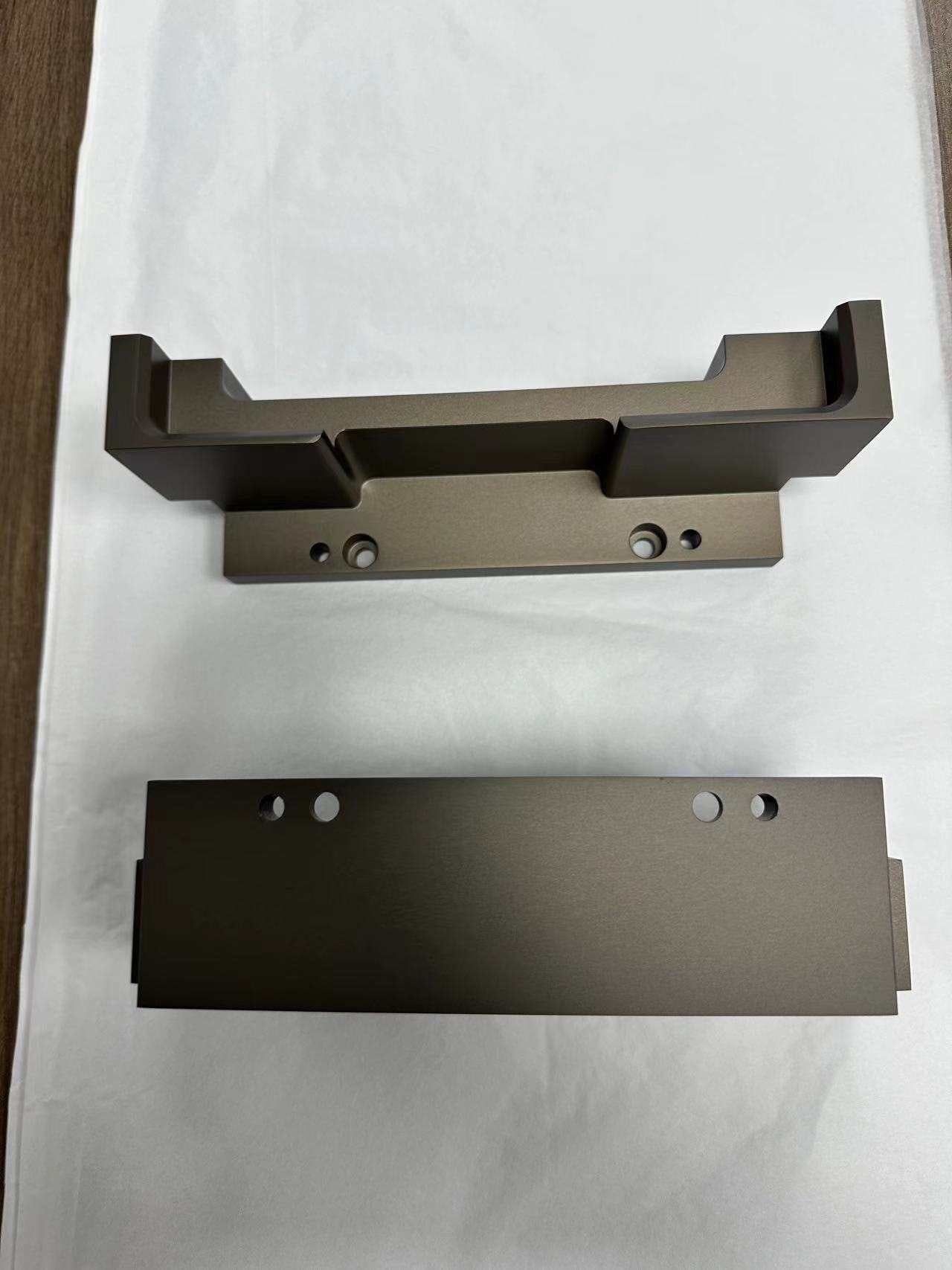A bronze anodized aluminum channel bracket and a matching plate